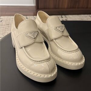 Prada women’s Glossy Cream Slip-On Loafers